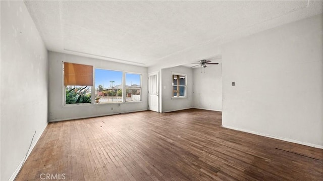 empty room featuring ceiling fan and dark hardwood / wood-style flooring