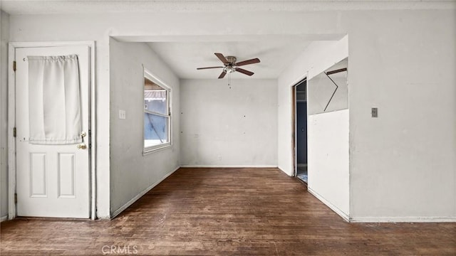 interior space featuring dark wood-type flooring and ceiling fan