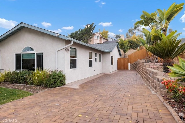 view of side of home with a patio