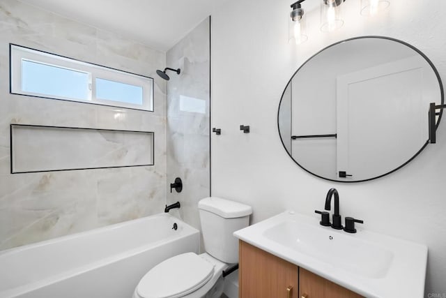 full bathroom featuring tiled shower / bath, vanity, and toilet