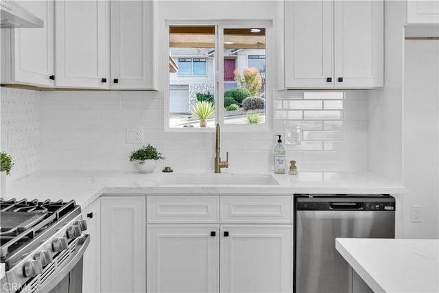 2741 Houston Dr, Los Osos, CA 93402 - kitchen featuring stainless steel dishwasher, white cabinets, under cabinet range hood, and a sink