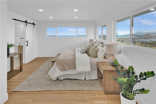 2741 Houston Dr, Los Osos, CA 93402 - bedroom featuring recessed lighting, baseboards, light wood-style floors, and a barn door