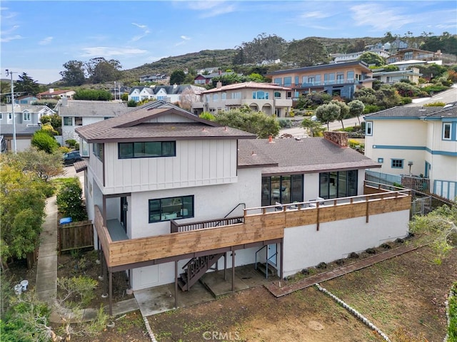 2741 Houston Dr, Los Osos, CA 93402 - back of house featuring fence, a shingled roof, stairs, a garage, and a residential view