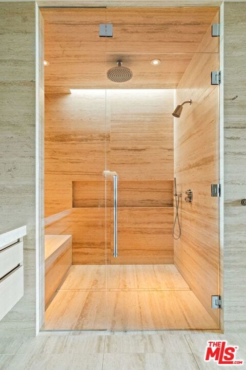 bathroom featuring a shower with shower door