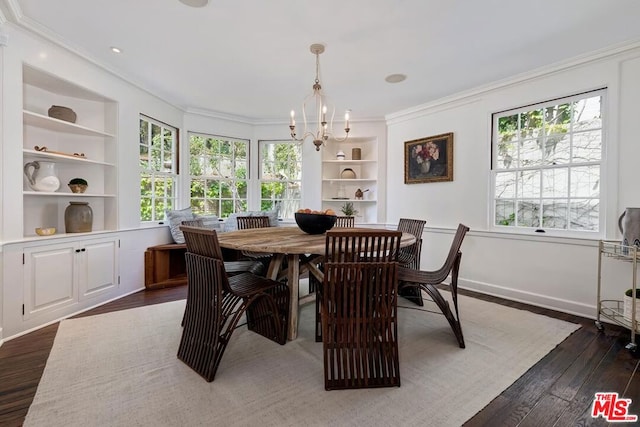 dining space featuring crown molding, dark hardwood / wood-style floors, a wealth of natural light, and built in shelves