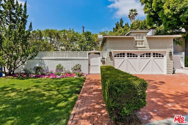 view of front of home featuring a garage and a front yard