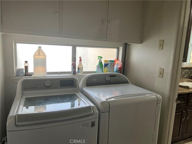 laundry room featuring cabinets and separate washer and dryer