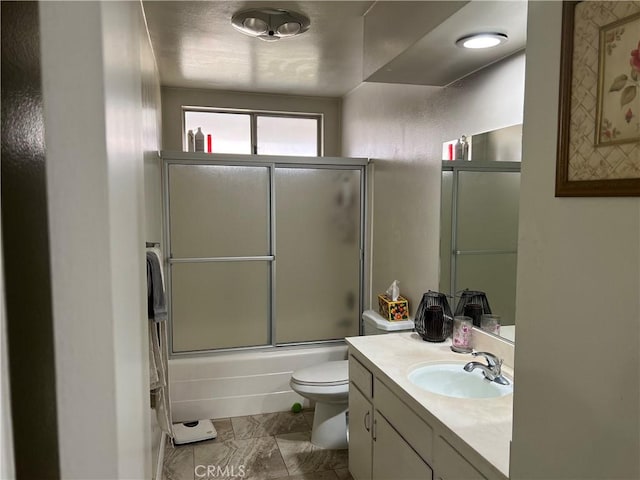 full bathroom featuring vanity, toilet, and combined bath / shower with glass door