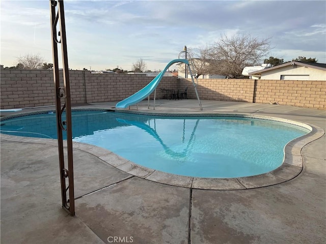 view of pool with a water slide