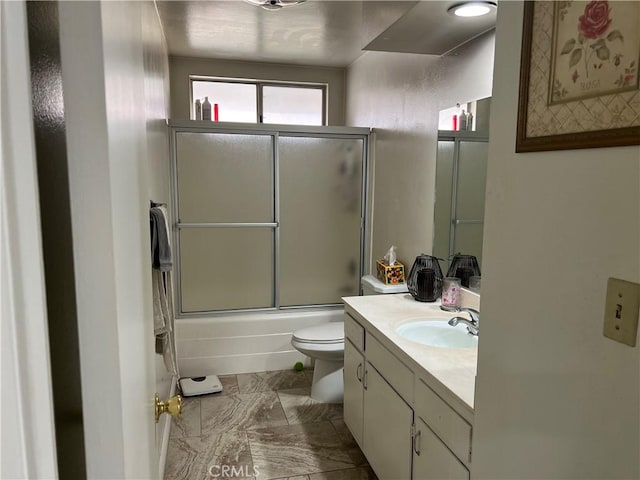 full bathroom featuring bath / shower combo with glass door, vanity, and toilet