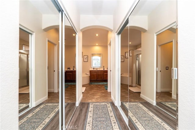 bathroom with an enclosed shower and hardwood / wood-style flooring