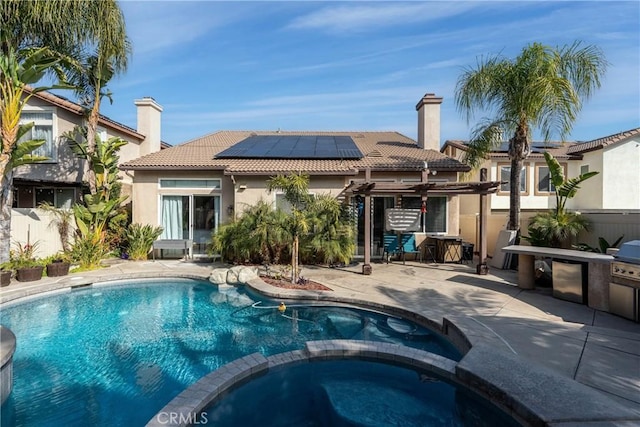 rear view of house featuring a pergola, a patio area, and solar panels