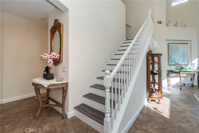 staircase with a high ceiling