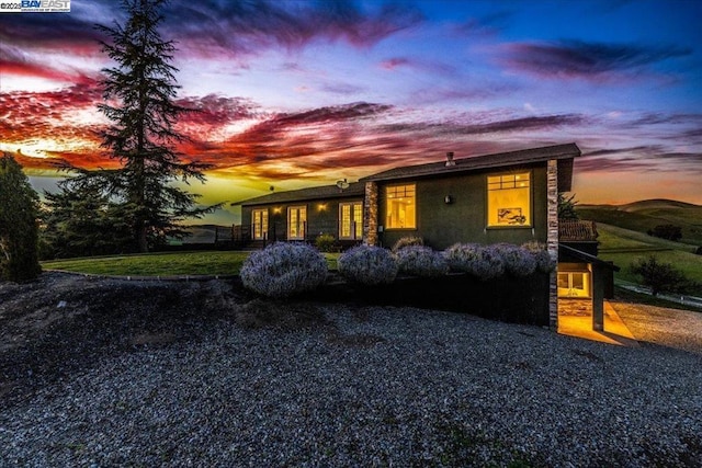 ranch-style home with a lawn