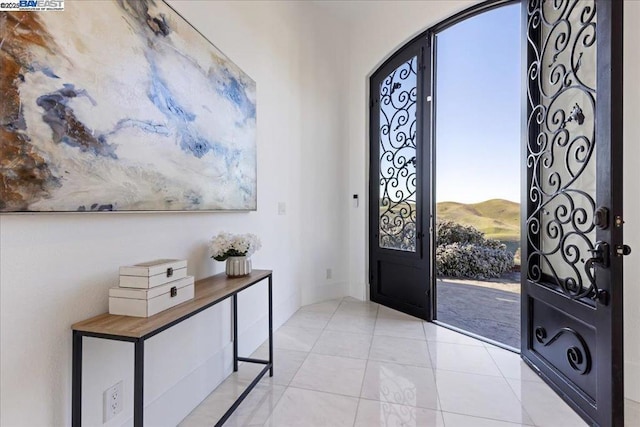 entrance foyer featuring light tile patterned flooring and a mountain view