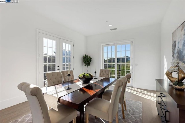 dining room with dark hardwood / wood-style flooring and french doors