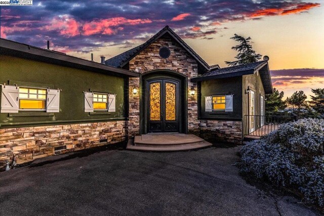 exterior entry at dusk with french doors