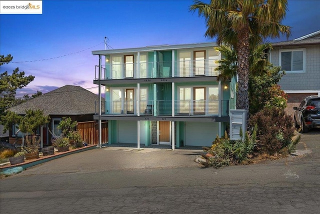 view of front facade featuring a balcony and a garage