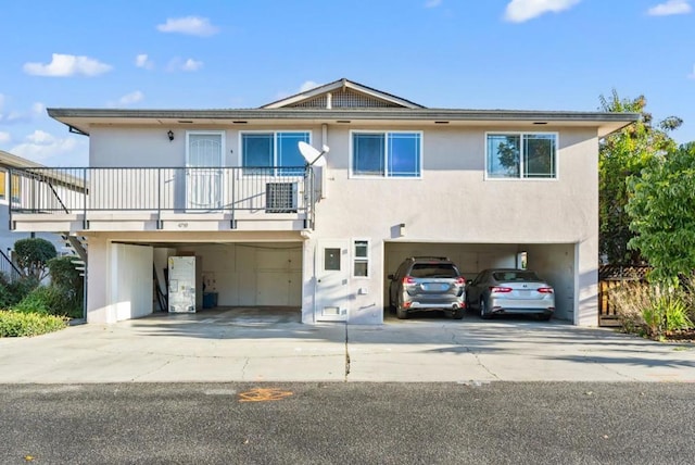 view of front of home featuring a garage and a balcony