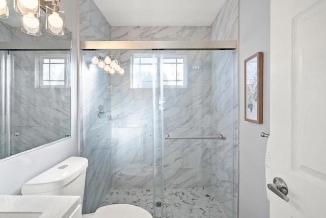 bathroom with vanity, a shower with shower door, and toilet