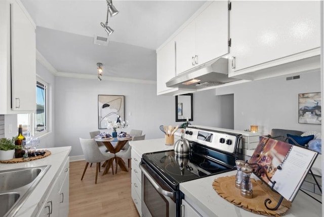 kitchen with crown molding, white cabinets, light wood-type flooring, and stainless steel electric range