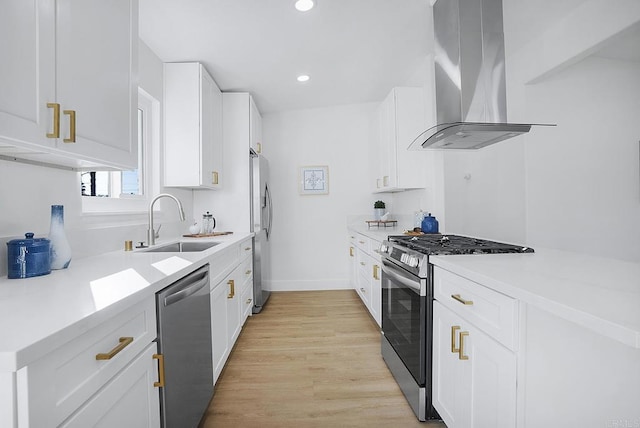 kitchen featuring sink, light hardwood / wood-style flooring, appliances with stainless steel finishes, white cabinets, and island exhaust hood