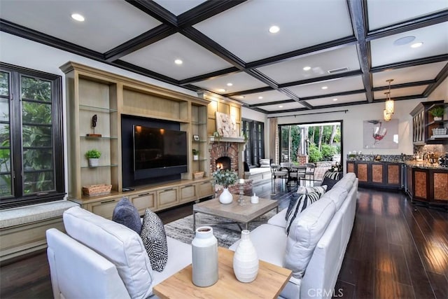 living room featuring a brick fireplace, coffered ceiling, dark wood-type flooring, and beam ceiling