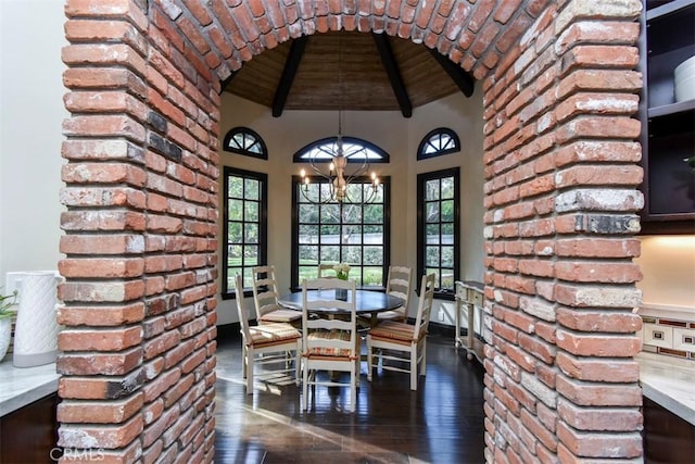 unfurnished dining area featuring dark wood-type flooring, wood ceiling, a chandelier, high vaulted ceiling, and beam ceiling