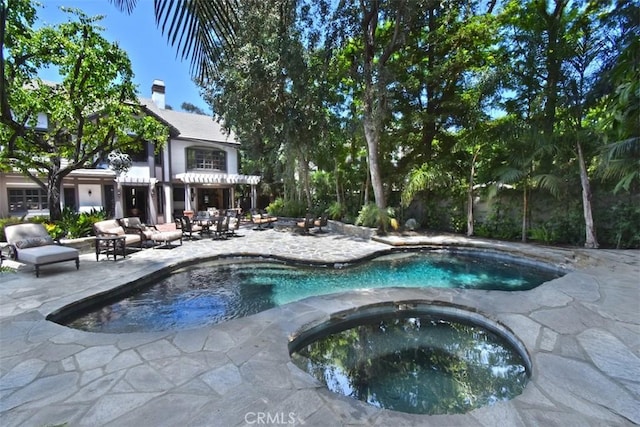 view of swimming pool with an in ground hot tub and a patio