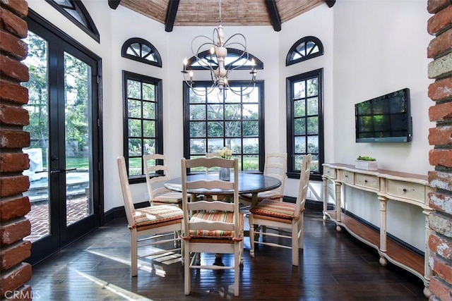 dining space featuring beam ceiling, high vaulted ceiling, dark hardwood / wood-style flooring, french doors, and a chandelier