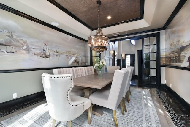 dining room with crown molding, a raised ceiling, and a notable chandelier