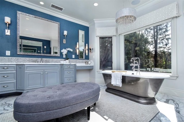 bathroom with vanity, a notable chandelier, crown molding, and a tub