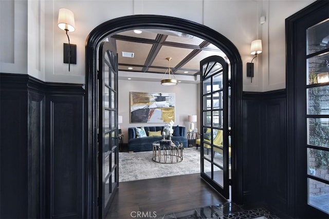 doorway to outside with beam ceiling, coffered ceiling, dark hardwood / wood-style flooring, and french doors