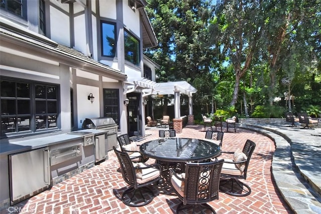 view of patio with a grill, a pergola, and exterior kitchen