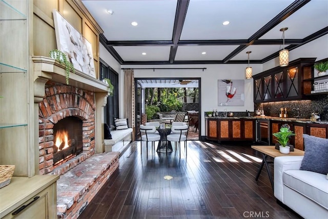 living room with a fireplace, indoor bar, coffered ceiling, dark wood-type flooring, and beam ceiling