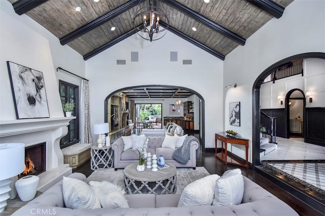 living room featuring an inviting chandelier, wood ceiling, beamed ceiling, and hardwood / wood-style flooring