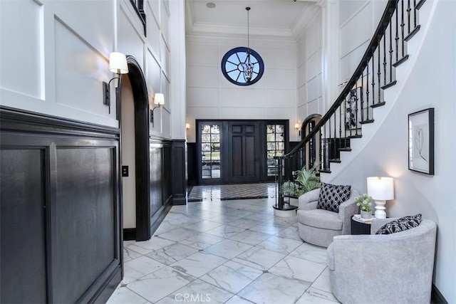 20514 Chatsboro Dr, Woodland Hills, CA 91364 - entrance foyer featuring light marble finish floors, a towering ceiling, a decorative wall, crown molding, and stairway