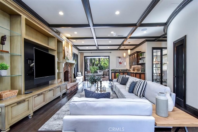 living room featuring a fireplace, dark hardwood / wood-style flooring, ornamental molding, coffered ceiling, and beam ceiling