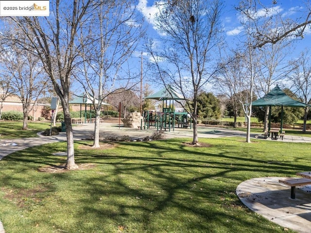 view of community with a lawn and a playground