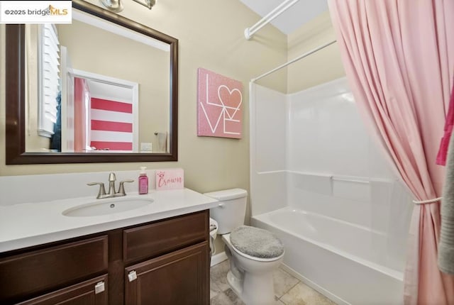 full bathroom featuring vanity, shower / bath combination with curtain, tile patterned floors, and toilet