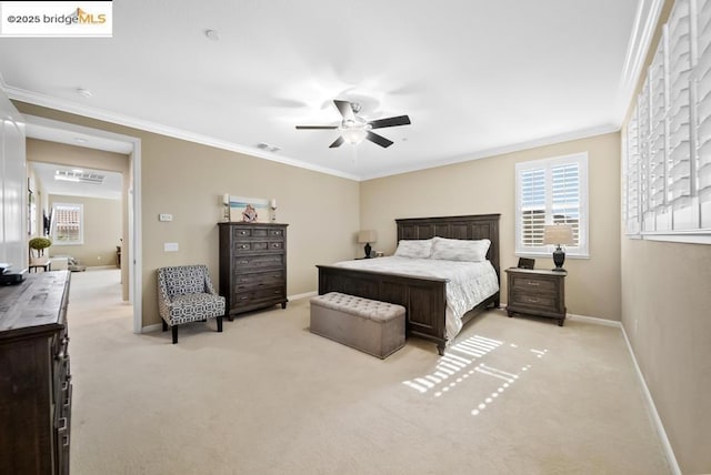 carpeted bedroom featuring ceiling fan and ornamental molding