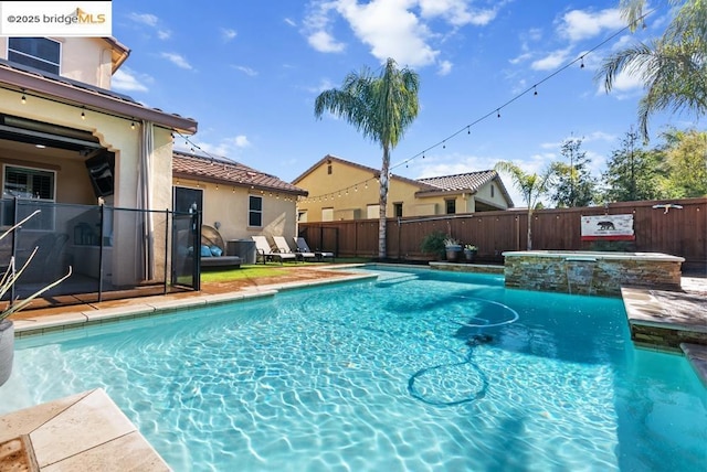 view of pool featuring an in ground hot tub