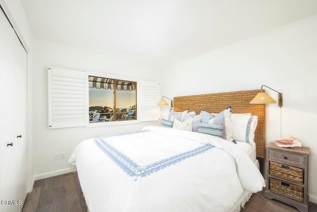 bedroom featuring a closet and dark hardwood / wood-style floors