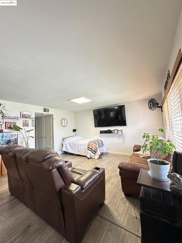 living room with hardwood / wood-style flooring and a textured ceiling