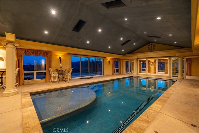 view of swimming pool featuring ornate columns