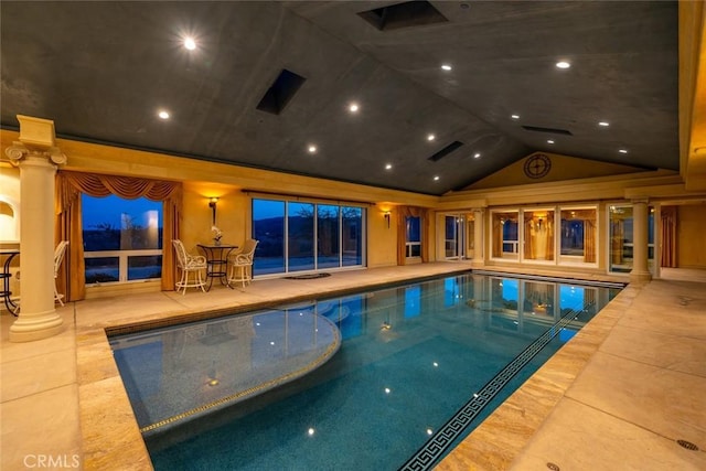 indoor pool featuring decorative columns