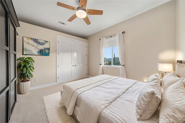 bedroom with light carpet, a closet, and ceiling fan