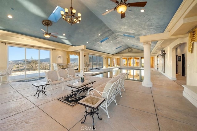 interior space with vaulted ceiling, ceiling fan, and ornate columns