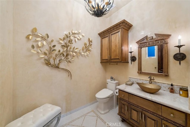 half bath with baseboards, toilet, tile patterned flooring, vanity, and a chandelier
