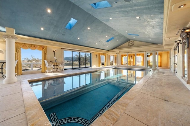 indoor pool with a skylight and decorative columns